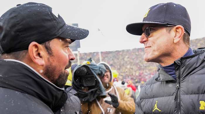 Ryan Day greets Jim Harbaugh after Michigan defeats Ohio State in 2021.